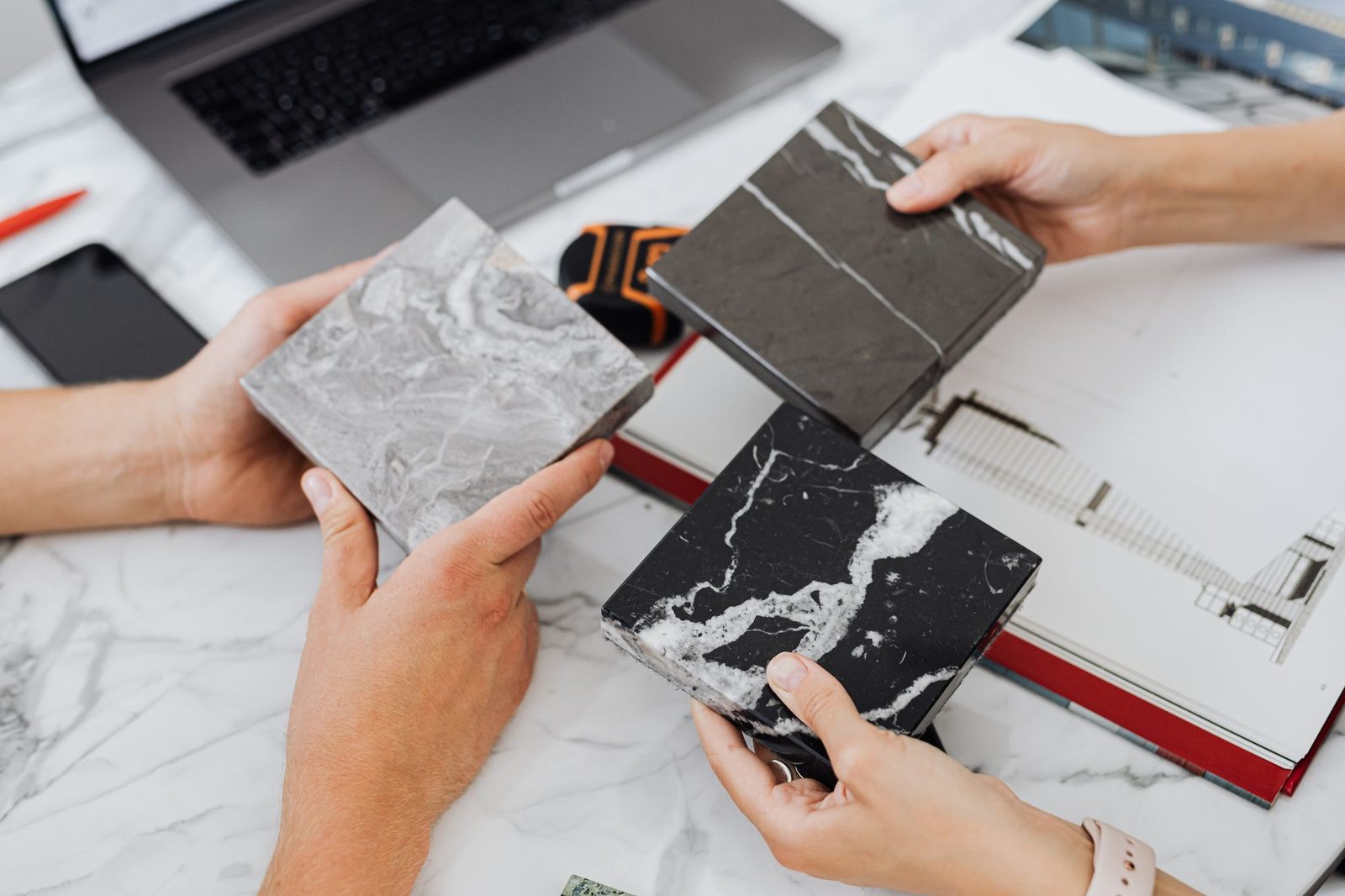 Two people choosing tile samples at a desk